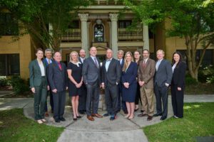 Bloom Parham Attorneys standing together posing for a picture outside the offices.